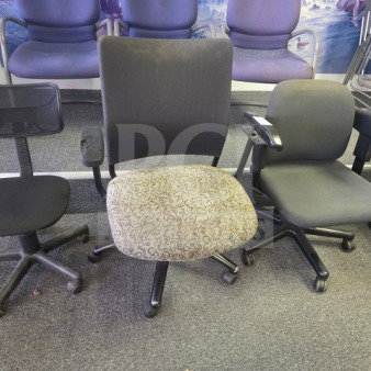 Lot of 3 office chairs showing signs of wear. Includes a mesh-back swivel chair, a patterned seat chair, and a padded armchair.