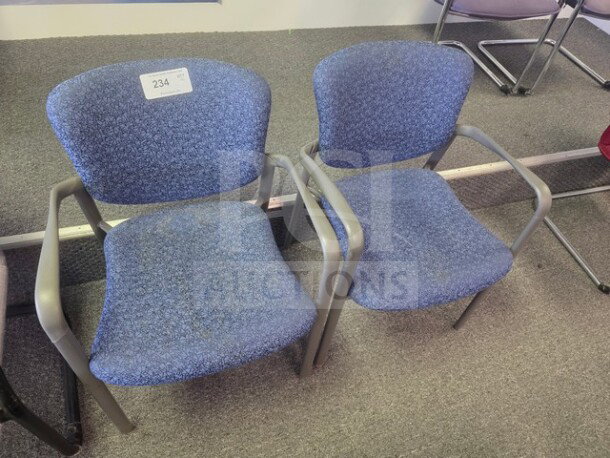 Lot of 2 blue fabric office chairs with gray metal frames, in used condition, labeled with auction number 234.