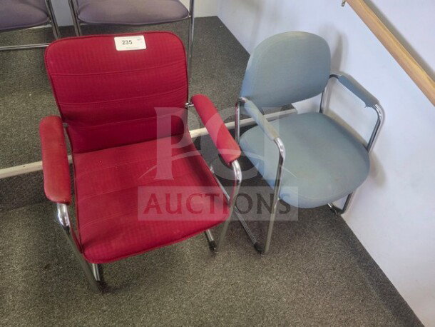 Lot of 2 office chairs; red fabric chair with label "235" and a blue fabric chair, both with metal frames, gently used.