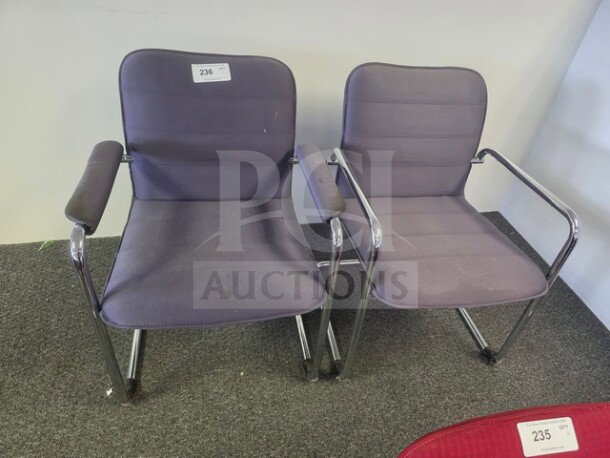 Lot of 2 purple office chairs with chrome frames and armrests. Minor wear visible. Label marked "236" on one chair.