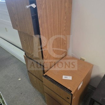 Lot of 3 wooden filing cabinets, stacked arrangement, light brown finish, varying sizes, visible labels, some wear.