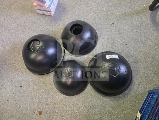 Four black Hybrid Athletics Atlas Stone Molds, varying sizes, used condition, markings visible for identification.