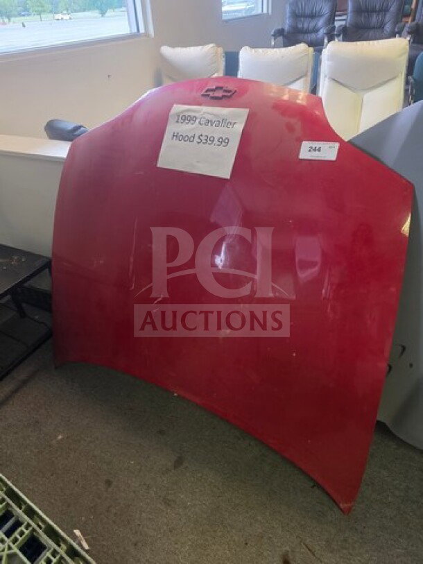 Red 1999 Cavalier hood for sale, priced at $39.99. Visible label attached with item name and price. In used condition.