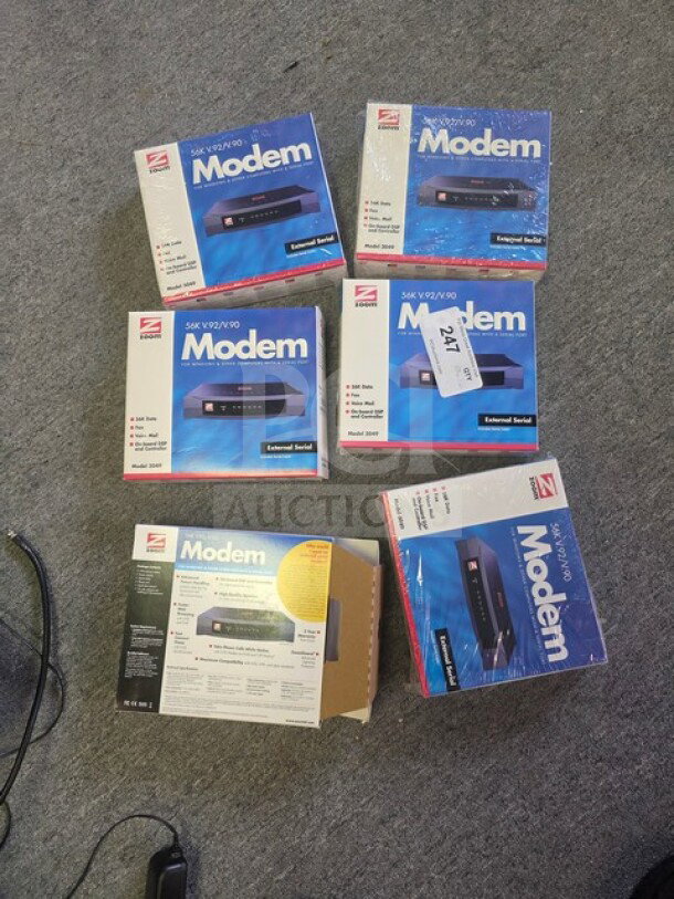 One lot of Zoom Model 3049 56K V.90/V.92 external serial modems in original packaging, showing model details and diagram.