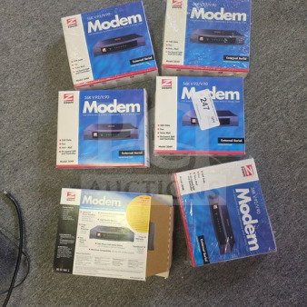 One lot of Zoom Model 3049 56K V.90/V.92 external serial modems in original packaging, showing model details and diagram.