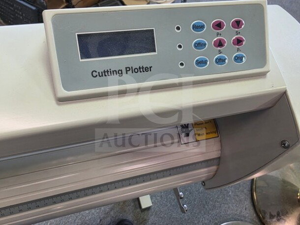 Cutting plotter with control panel featuring buttons and display, in good condition. Visible label with plotter name.