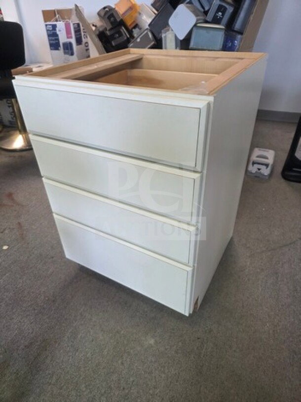 White drawer base cabinet with four drawers, minor wear on edges, no hardware, in clean condition.