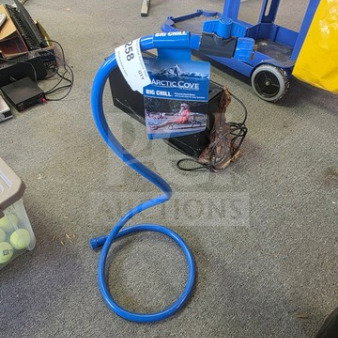 Arctic Cove personal stand mister with blue hose, new in box. Includes label indicating model. Ideal for outdoor cooling.