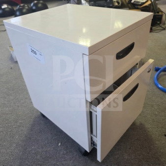 White filing cabinet with two drawers, black handles, and wheels. Item tag reads "259." Good condition.