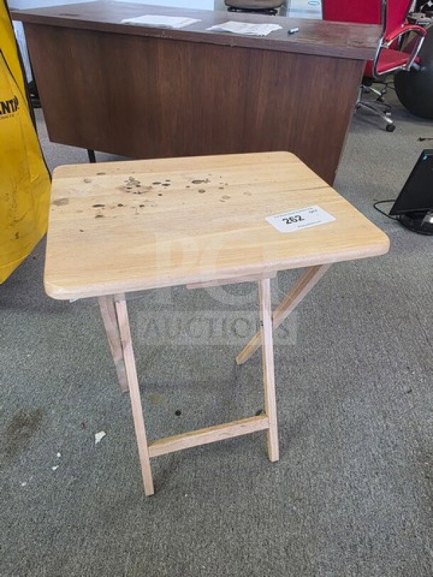 Folding tray table, light wood, surface wear visible, rectangular top, collapsible legs for easy storage, auction tag 282.