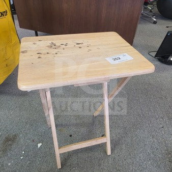 Folding tray table, light wood, surface wear visible, rectangular top, collapsible legs for easy storage, auction tag 282.