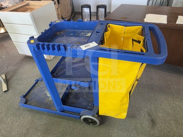 Blue janitor cart with a yellow bag, two wheels, and multiple compartments. Used condition with visible wear. Item number 262.