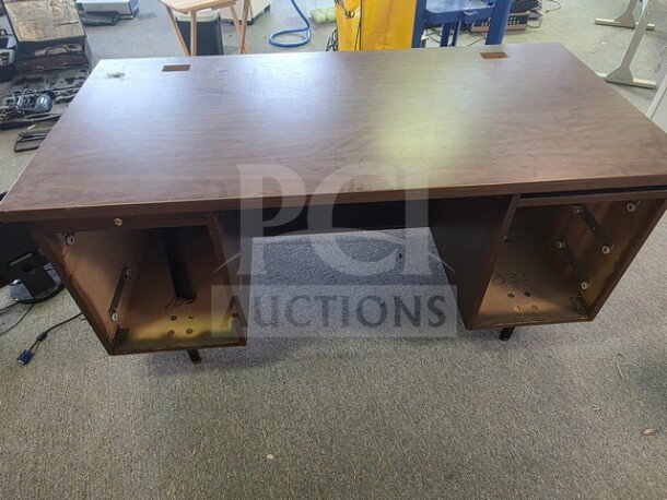 Pedestal desk with missing drawers, wooden surface, no visible brand or markings, in used condition.