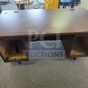 Pedestal desk with missing drawers, wooden surface, no visible brand or markings, in used condition.