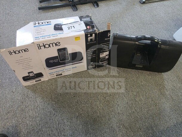 One lot with iHome app-enhanced alarm clock in box and iLuv player. Unknown working condition, sold as is.