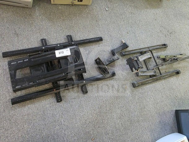 Lot of miscellaneous TV wall mounts on display, includes various sizes and styles. Visible tag numbered 272.