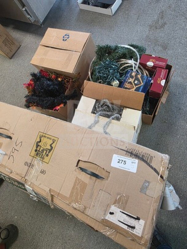Lot of miscellaneous Christmas decorations in various boxes, including garlands, lights, and ornament packaging. Mixed condition.