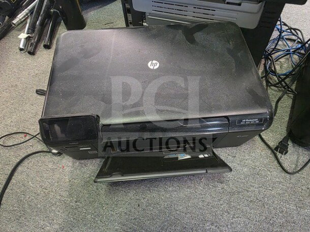 Lot with HP printer, visible scratches; includes a paper shredder and fax machine. Used, condition shows wear.