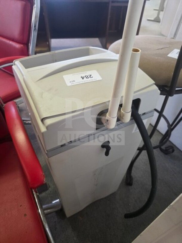 Water Boss Water Softener in used condition, features top panel, attached pipes, tag labeled "284," compact design.