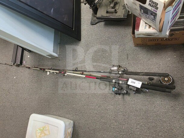 Lot of miscellaneous fishing poles, various sizes and models, mixed materials, used condition, auction tag labeled "286".