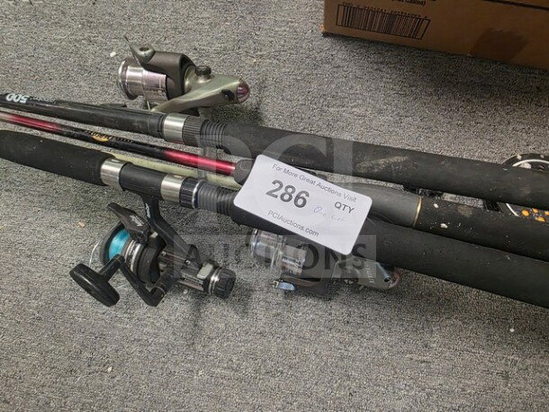 Lot of miscellaneous fishing poles with reels, varied styles, in used condition. Auction tag displays "286" and auction website.