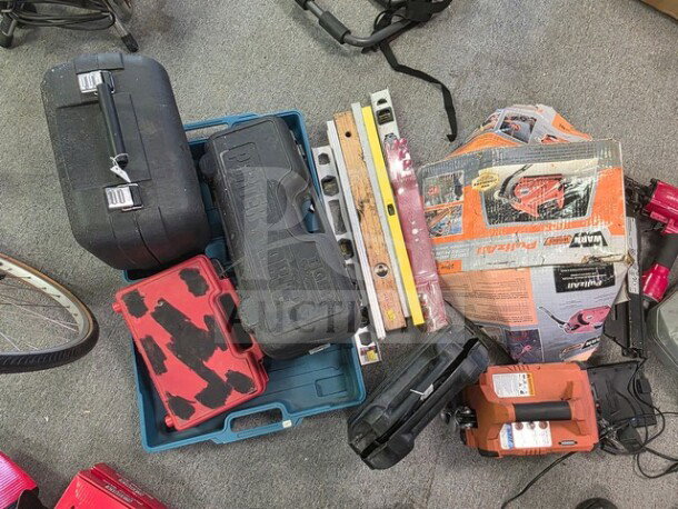 Assorted lot of hand tools including levels, cases, and drill. Various conditions, sold as is.