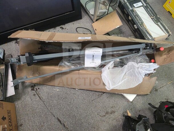 Climbing machine in original packaging, partially assembled, with a visible tag labeled "Climbing Machine," appears unused.