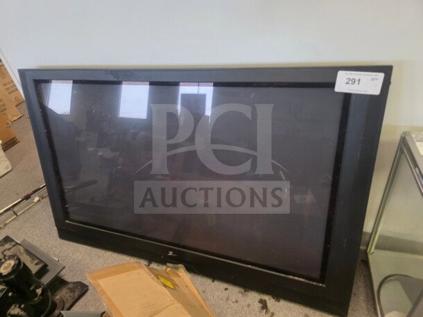 Plasma television with unknown working condition, sold as is. Black frame, floor standing, auction tag number 291 attached.