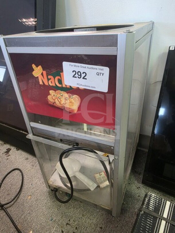 Commercial nacho chip warmer with branding, clear front panel, and heating element. Item tag reads "292 QTY." Used condition.