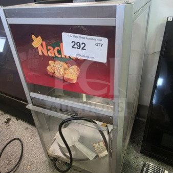 Commercial nacho chip warmer with branding, clear front panel, and heating element. Item tag reads "292 QTY." Used condition.