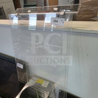 Clear acrylic sneeze guards in lot with mounting brackets, visible label "294", excellent condition.