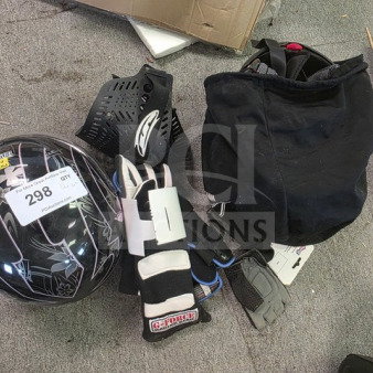 Lot of miscellaneous racing gear including a helmet, protective pads, gloves, and a racing suit. Helmet labeled "298 GQT."