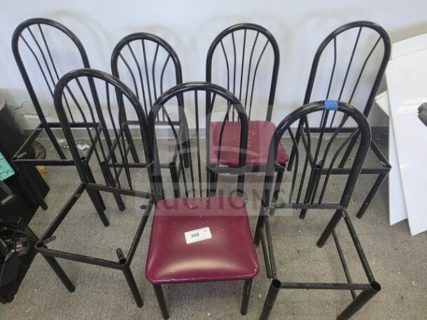 One lot of black metal chair frames, arched backs, one with a burgundy seat. Includes tag marked "300." Used condition.