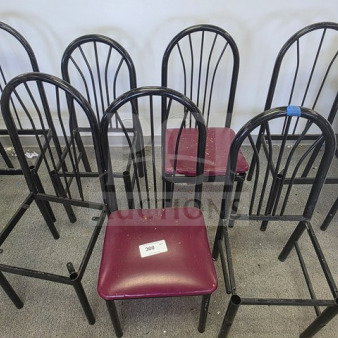 One lot of black metal chair frames, arched backs, one with a burgundy seat. Includes tag marked "300." Used condition.