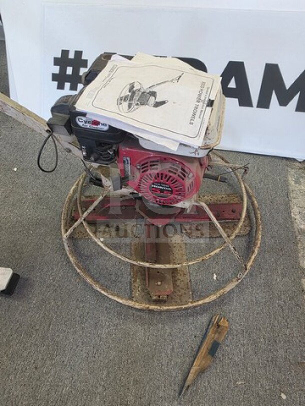 EDCO Power Trowel, red and silver, unknown working condition, sold as is, visible manual on top, used for smoothing concrete surfaces.