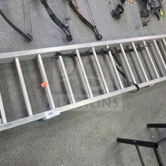 Aluminum loading ramp, lightweight and durable, with 11 rungs. Visible labels include a lot number and safety strap.