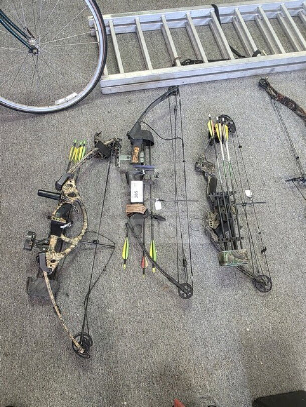 Lot of 3 compound bows in camo pattern, each with arrows and attachments. Excellent condition, ready for use.