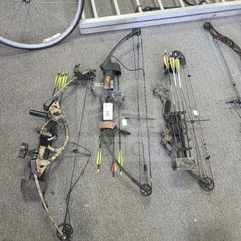 Lot of 3 compound bows in camo pattern, each with arrows and attachments. Excellent condition, ready for use.