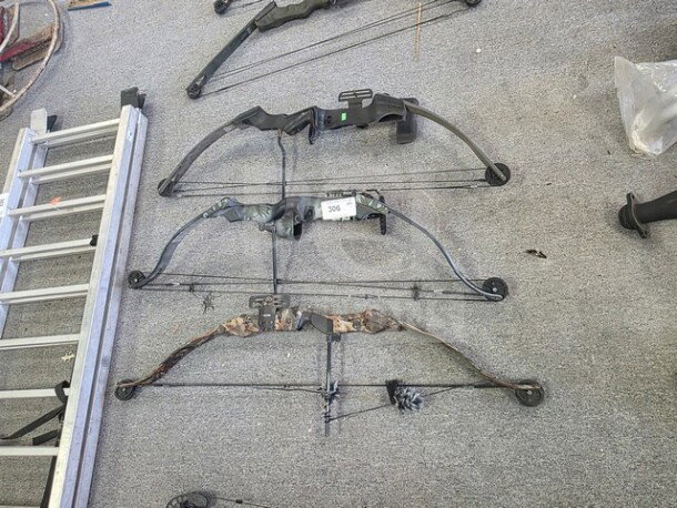 Lot of 3 compound bows in varying conditions. Includes black, camouflage, and dark green models. Tags indicate item number 306.