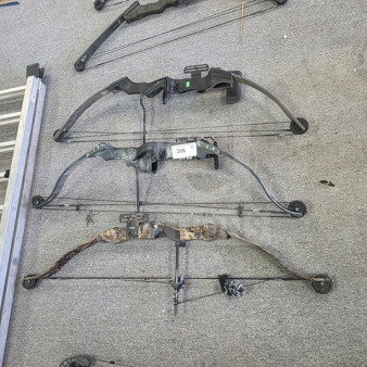 Lot of 3 compound bows in varying conditions. Includes black, camouflage, and dark green models. Tags indicate item number 306.