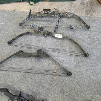 Lot of 3 compound bows, camo design, featuring pulleys and cables. Includes sight, stabilizer, in used condition. Item tag 307.