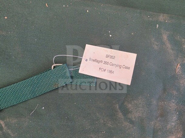 Bowflag Carrying Case, model 200, with tag showing PO# 1864, in used condition. Green fabric, sturdy strap.