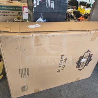 "2PC ATV Basket Set in sealed box, brown cardboard packaging with visible product label and various markings."