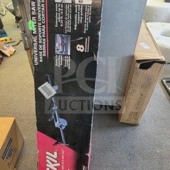 Universal Miter Saw Stand in original SKIL packaging. Key features and specifications are listed on the box. Some wear visible.