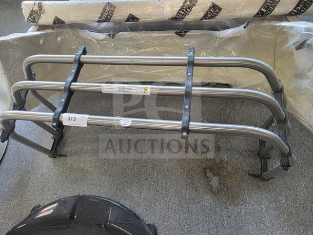 Ford F-150 bed extender, silver metal frame, light wear. Includes mounting hardware. Auction tag 313 visible.