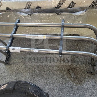 Ford F-150 bed extender, silver metal frame, light wear. Includes mounting hardware. Auction tag 313 visible.