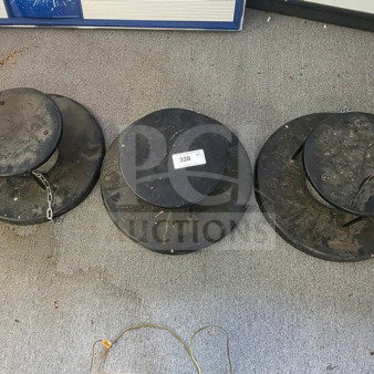 Lot of 3 black weighted umbrella stand bases, used condition, visible wear and dirt, one base with a chain. Tag marked "320."