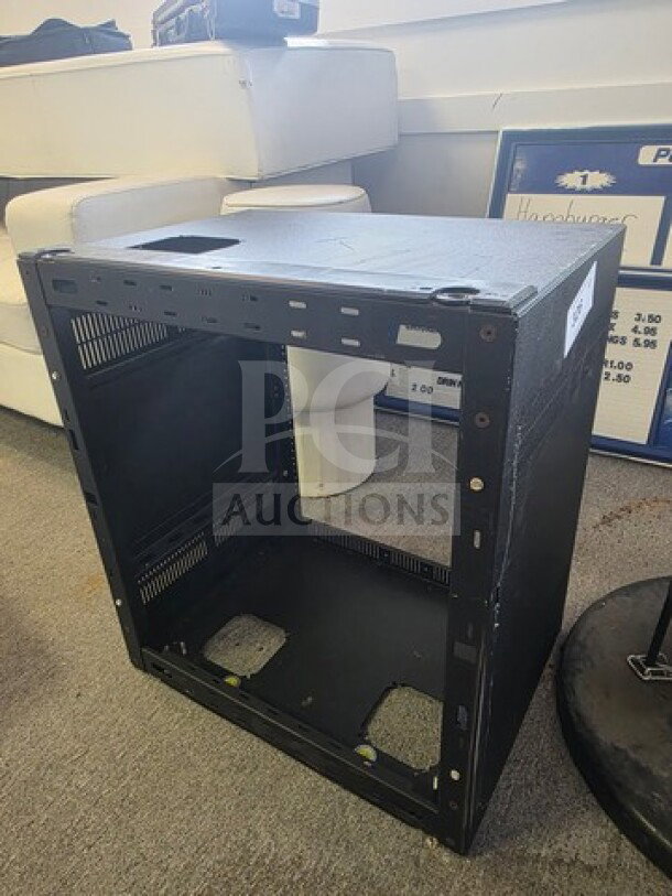 Open-frame wall-mount server rack, black metal, used condition, with ventilation slots and mounting holes.