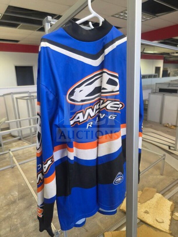 Blue Answer Racing motocross jersey, featuring logo and stripes, in good condition, hanging on a white hanger.