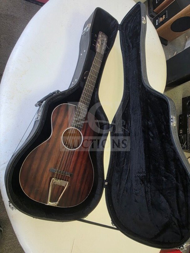 Vintage Cowboy Loye parlor guitar in dark wood finish, displayed in open black case. Sold as is.